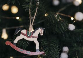 Composition of christmas tree with wooden horse ornament